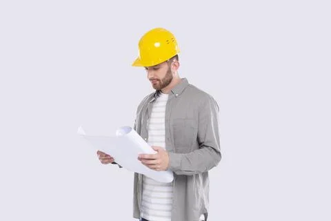 Construction Worker Looking at House Plan. Architect Holding Blueprints. Yellow Stock Photos