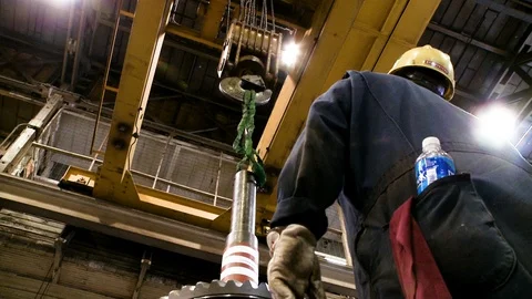 Construction worker looking up at large crane hook Stock Footage 123728434