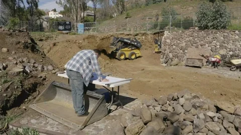 Construction worker looking at plans at a house construction site Stock-Footage 133844208