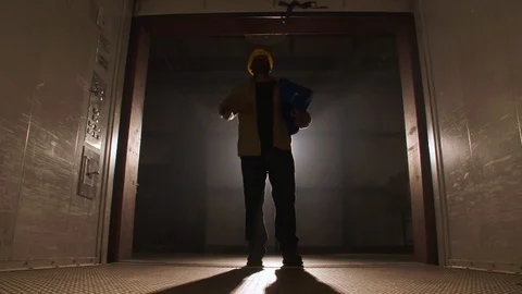 Construction Worker Lowers Elevator Gate Stock Footage 127329393