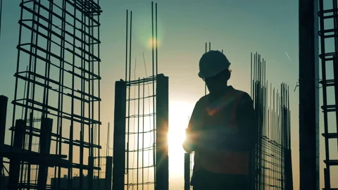 Construction worker is making calculations on a roof at sunset Stock-Footage 133767839