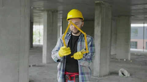 Construction worker making house shape with folding ruler Video stock 337467514