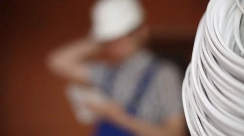 Construction worker making notes in a notebook on the background coil cable Video stock 61696491