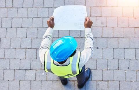 Construction worker, man and building inspection blueprint with industrial Fotos de archivo