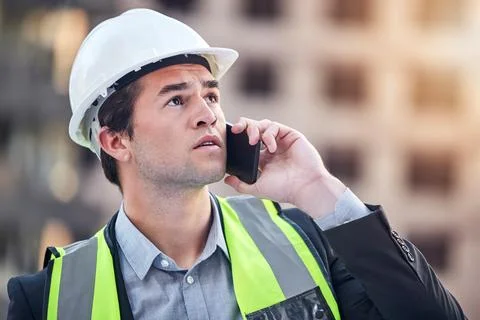 Construction worker, man and phone call for industry in city in helmet, stress Stock Photos