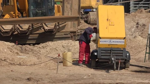 Construction worker man fill generator machine with diesel fuel Video stock 68758184