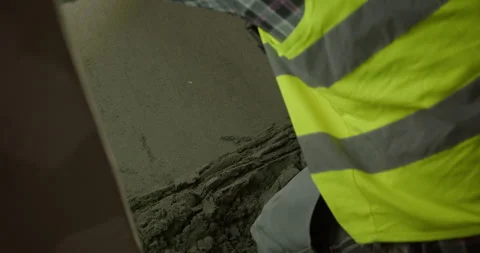 Construction Worker Manually Troweling a Sand and Cement Floor Screed Stock Footage 315432240