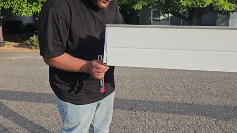 Construction worker manufacturing new rain gutters, stapleing end cap Stock Footage 247781840