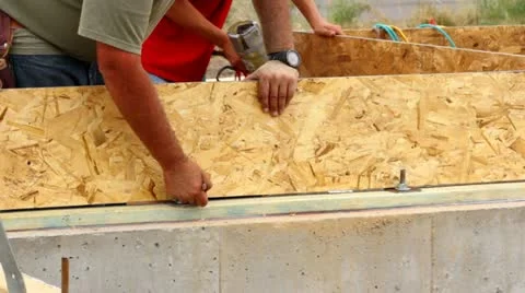Construction worker marking where to cut on board Stock Footage