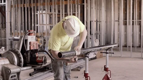 A Construction Worker Measures A Pipe And Marks It 스톡 동영상 87484121