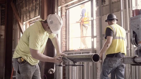 A Construction Worker Measures A Pipe And Marks It Stock Footage 87484195