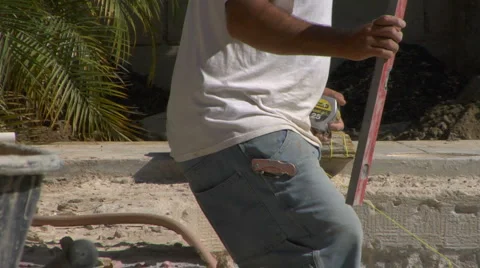 Construction worker measures pool remodel Stock Footage 889428