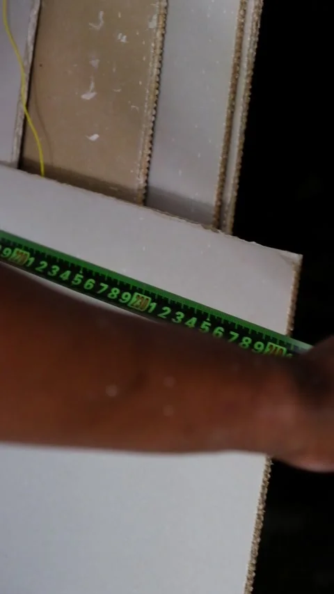 Construction Worker Measuring Drywall Board using Tape Measure Stock-Footage 342883118