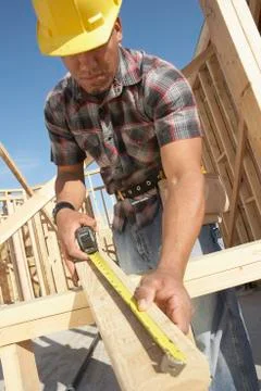 Construction Worker Measuring Timber Stock Photos