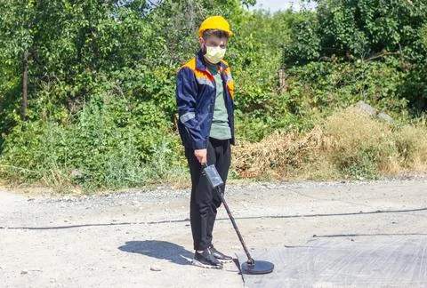Construction worker with metal detector 스톡 사진