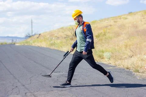 Construction worker with metal detector 스톡 사진