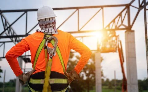 Construction Worker on Metal Structure at Sunset Stock Photos