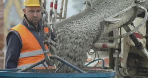 Construction worker, mixer truck pipe pouring concrete in bowl at building site Video stock 146395509