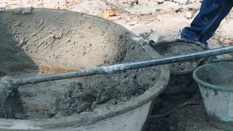 Construction worker mixes wet grey cement in basin. Video stock 147176348