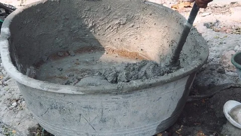 Construction worker mixes wet grey cement in basin. Stock Footage 147669621