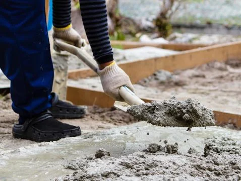 Construction worker mixing cement Stock Photos