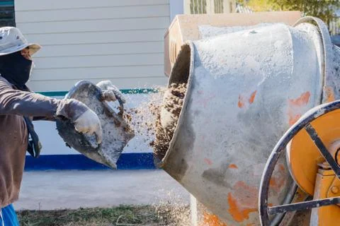 Construction Worker Mixing Cement Stock Photos