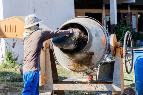 Construction Worker Mixing Cement Stock Photos