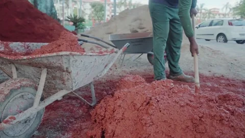 Construction worker mixing clay and straw for wattle and daub Stock Footage 341301587