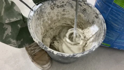 Construction worker mixing concrete bucket moving shot Stock Footage 161905505