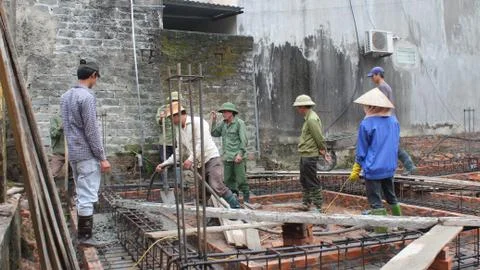 Construction worker mixing concrete Stock Photos