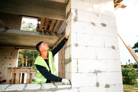Construction worker monitors build quality, inspects masonry, verifies fit,.. Stock Photos