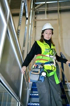 Construction worker mounting plasterboard on metal frame Stock Photos