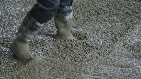 Construction worker moves liquid concrete Stock Footage 77103089