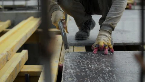 Construction worker nailing formwork board Stock Footage 314234375