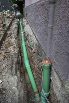 Construction worker, newly laid green sewage pipes, trench, Stuttgart, Stock Photos
