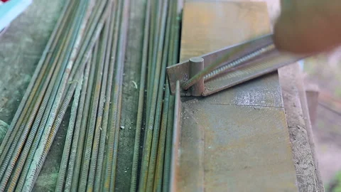 Construction worker in old uniform bends construction iron fittings. Stock Footage 102158239