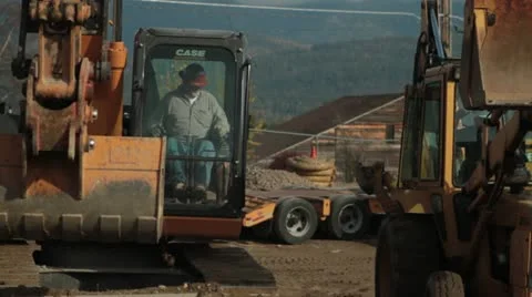 Construction worker operates excavator Stock Footage 21562969