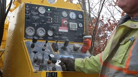 Construction worker operates well drilling controls front Stock Footage 77278287