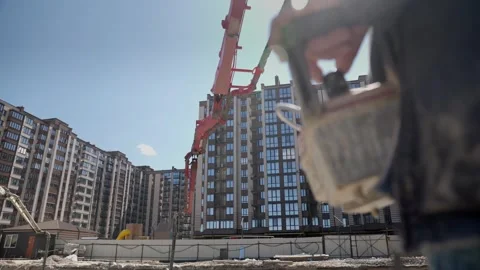 Construction worker operating concrete pump remote control Stockbeeldmateriaal 333705303