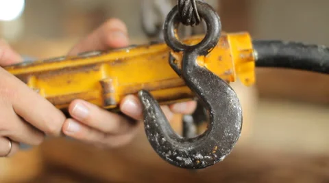 Construction worker operating a crane in assembly hall. Remote and hook in the Stock Footage 65205813