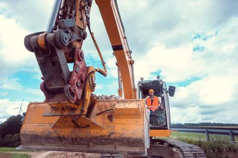 Construction worker operating the crawler excavator 스톡 사진