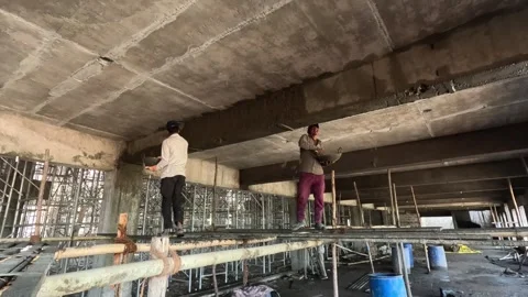 Construction Worker Operating Hand Cart to Move Cement Blocks at Building Stock Footage 340564320