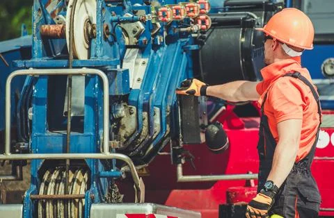 Construction Worker Operating Machinery on a Job Site During Daylight Hours Photos