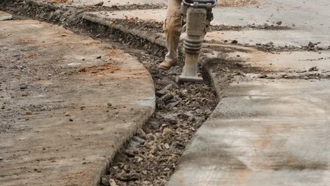 Construction worker operating rammer Stock Footage 106365282