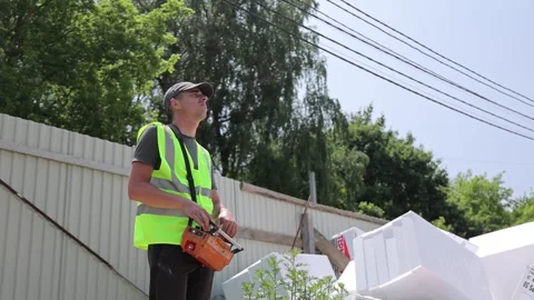 Construction Worker Operating Remote Control Device, Safety vest and cap under Stock Footage 312168605