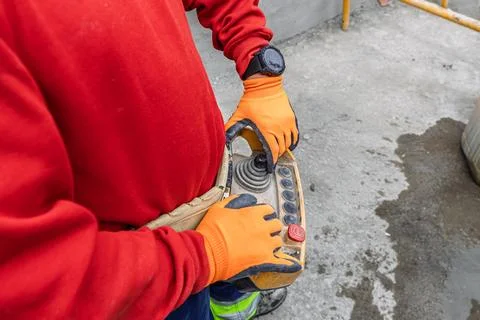 Construction worker operating remote control at building site Stock Photos