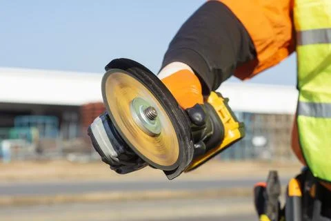 Construction worker in orange and black protective clothing and high-visibi.. Stock Photos