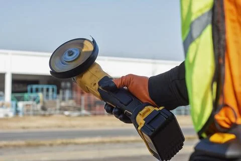 Construction worker in orange and black protective clothing and high-visibi.. Stock Photos