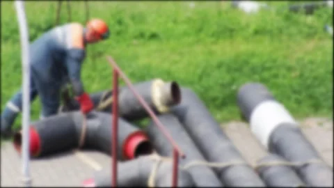 Construction worker in orange hard hat and blue work uniform prepares large Stock Footage 344864182