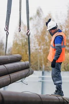 Construction Worker Overseeing Heavy Lifting Operations Stock Photos